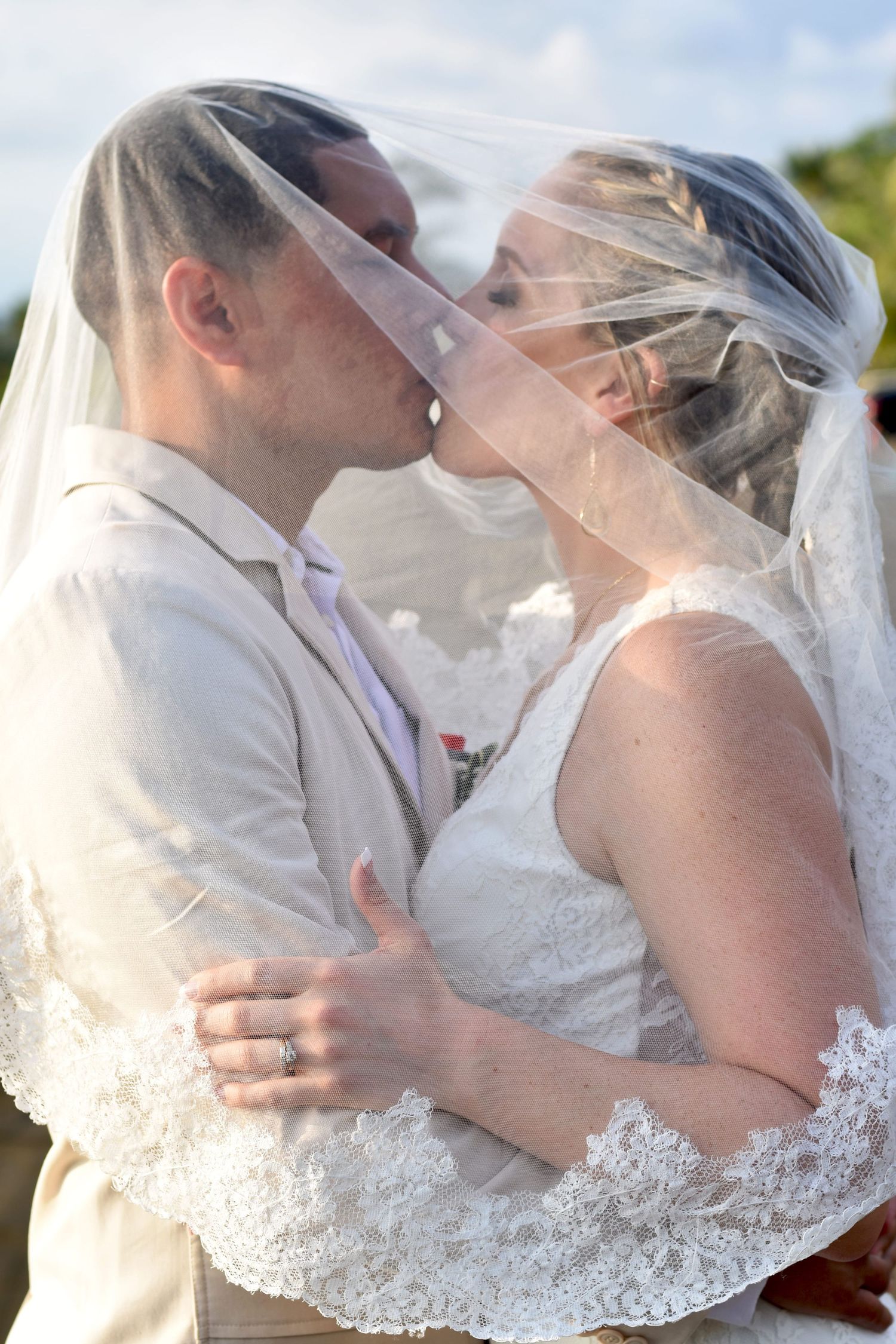 Bride and Groom kissing under the veil in Costa Rica