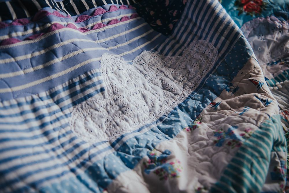 Patchwork sky of a memory quilt with a cloud applique.