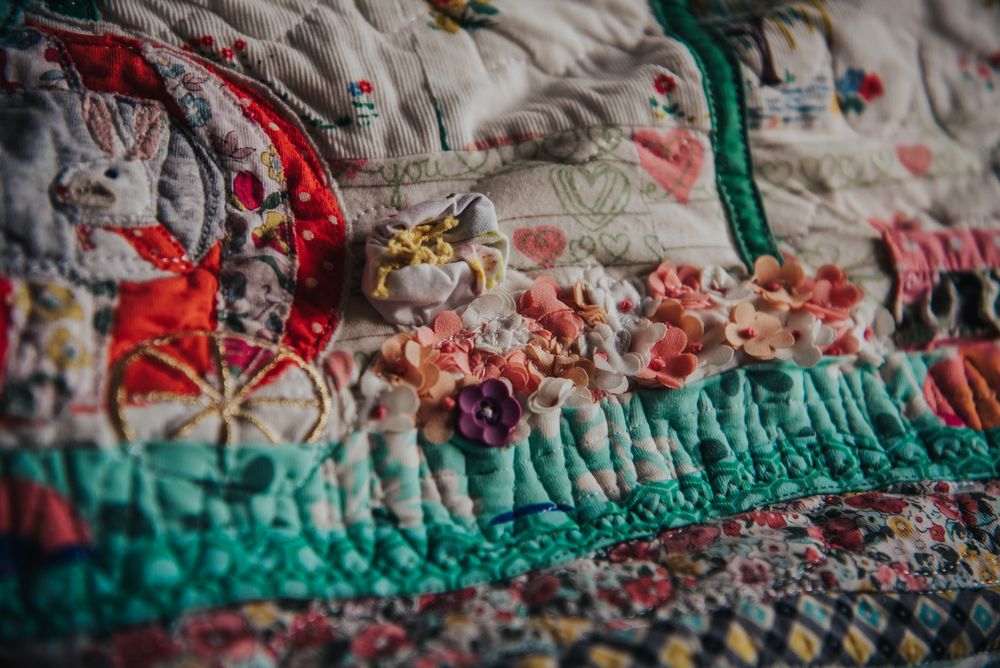 Custom flower applique on a memory quilt.