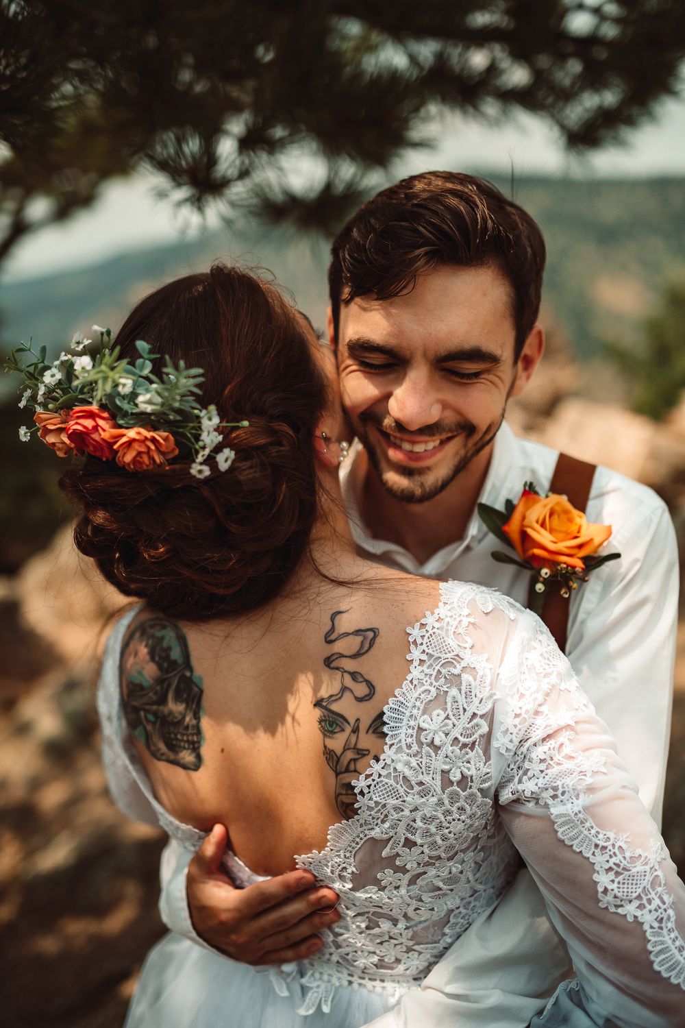 Intimate wedding portrait showing lace dress details and floral boutonniere.
