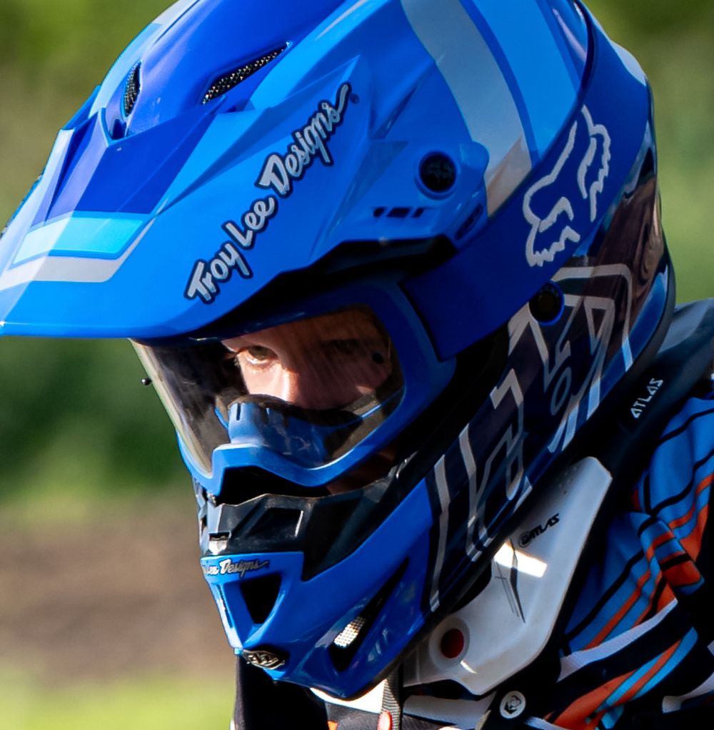 Close-up sequence of blue and white motocross helmet details during race.