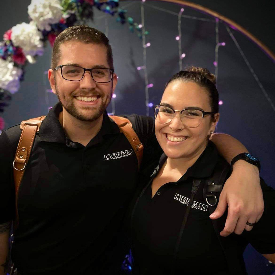 Professional photography team members smiling together in matching uniforms.