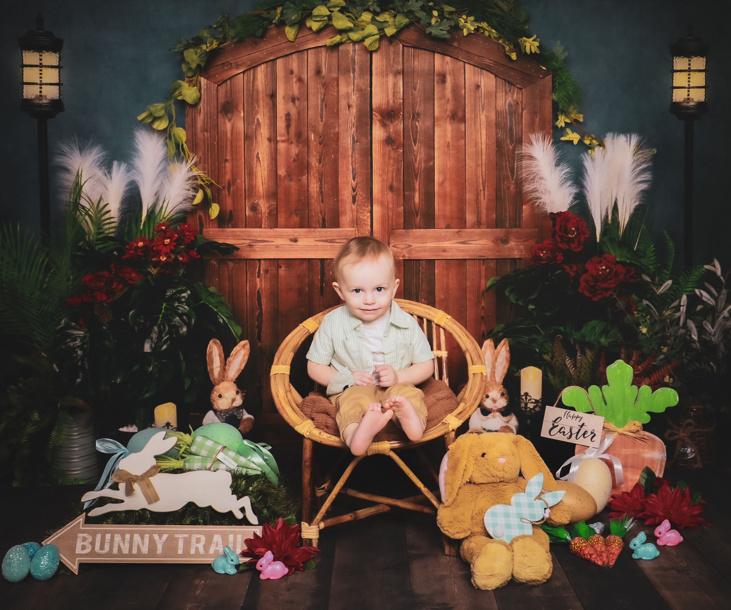 Easter photo setup with rustic wooden backdrop, plush bunnies, and colorful spring decorations.