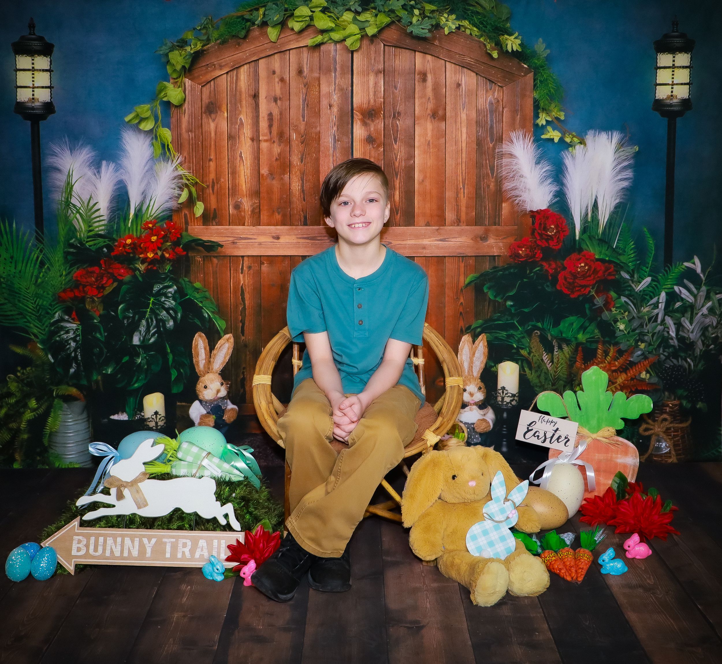 Easter themed photo session backdrop with wooden panels, stuffed animals and spring decor.