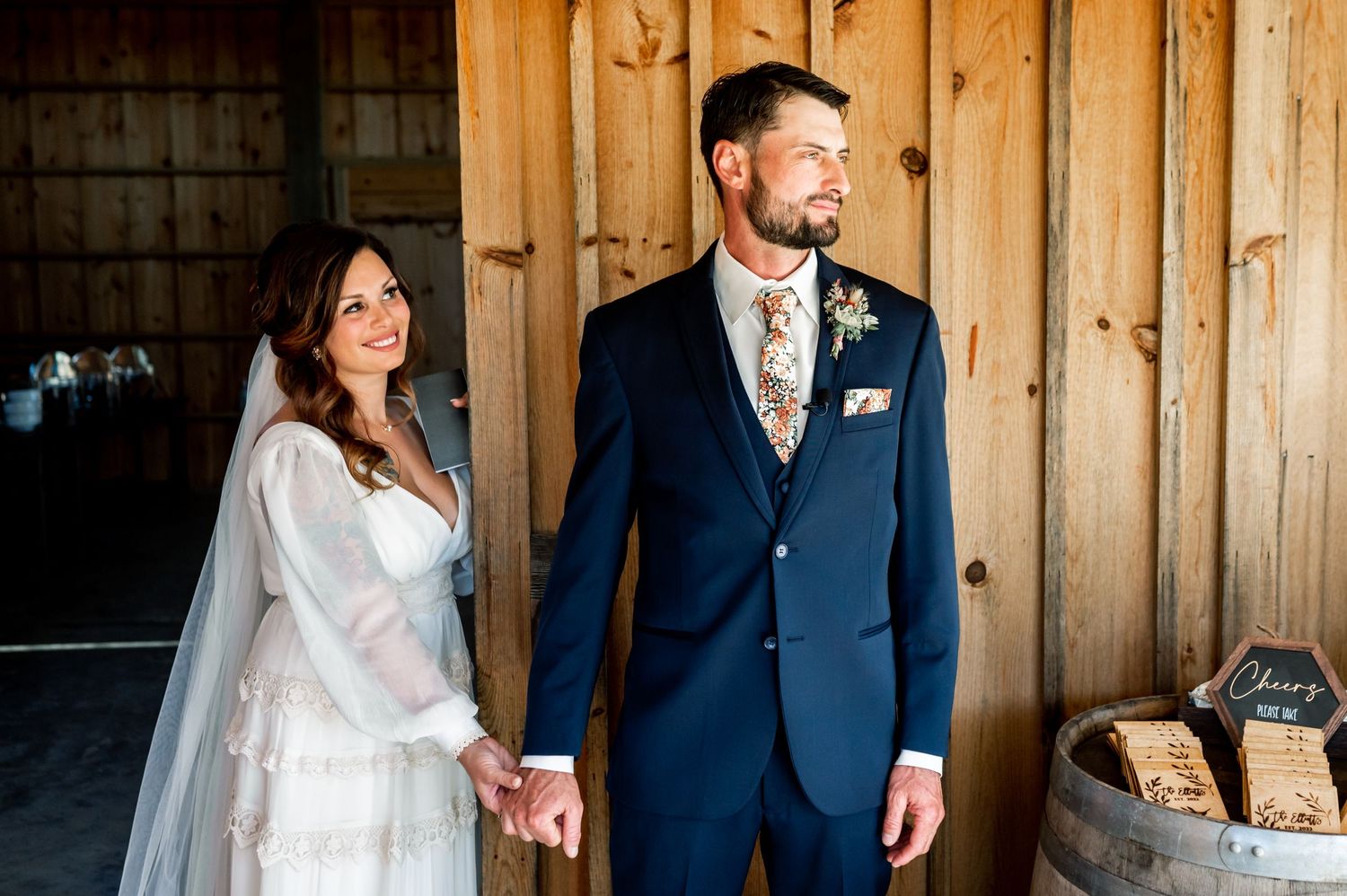 Rustic barn wood backdrop frames elegant wedding day portraits.