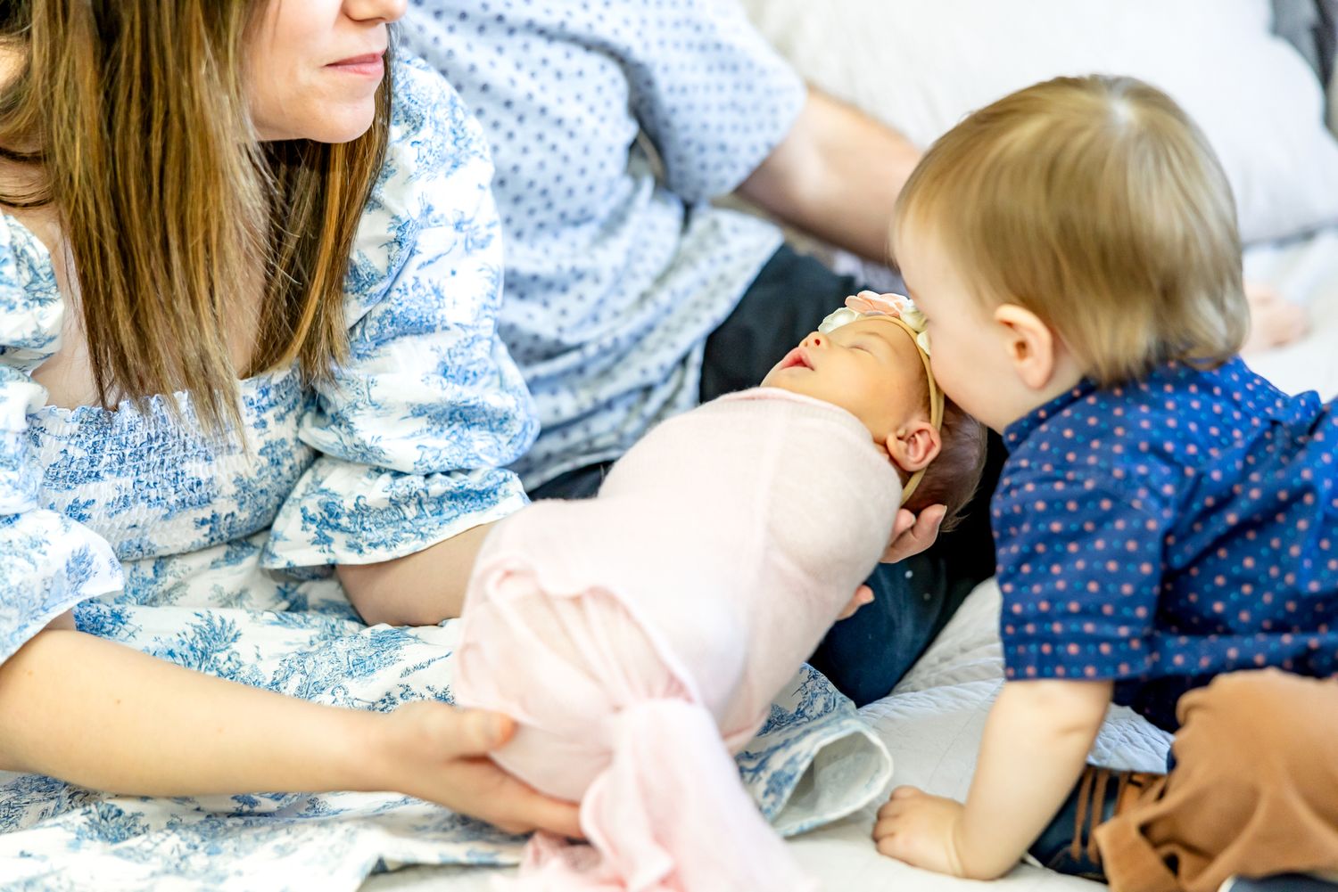 Close up of toddler boy kissing his new baby sister during newborn photos in Colorado Springs.