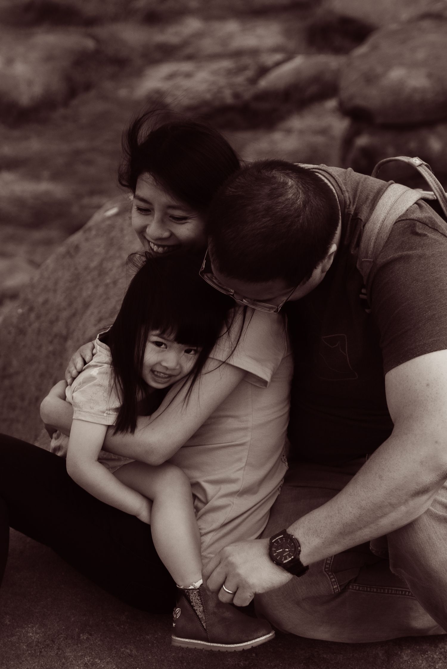 black and white family portrait, hugging family