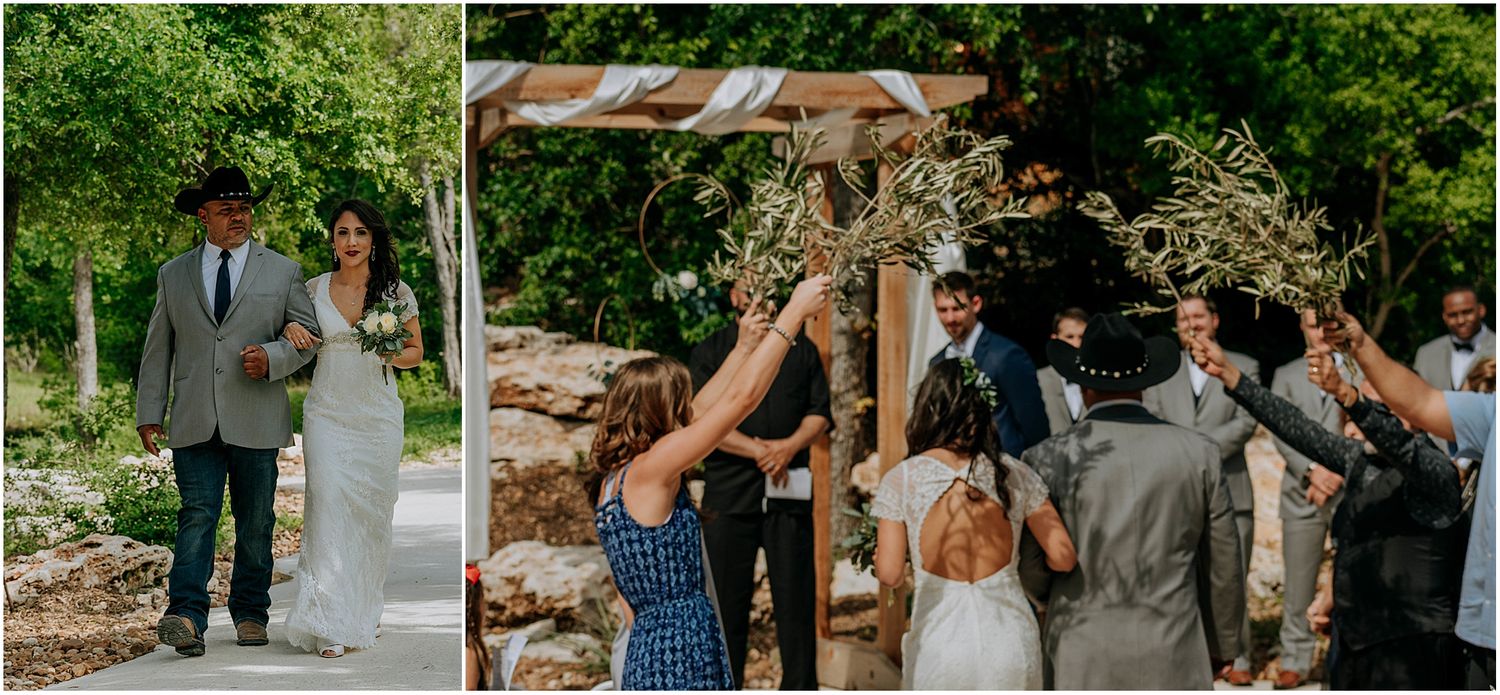 A wedding celebration showing guests cheering under a wooden pergola decorated with flowing white fabric.