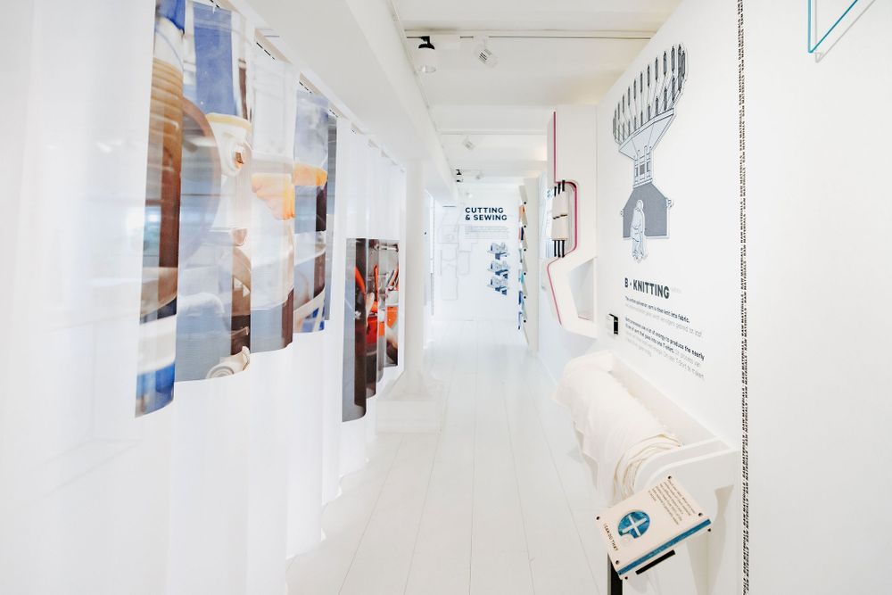 Bright corridor gallery with modern artwork and graphic designs mounted on pristine white walls.
