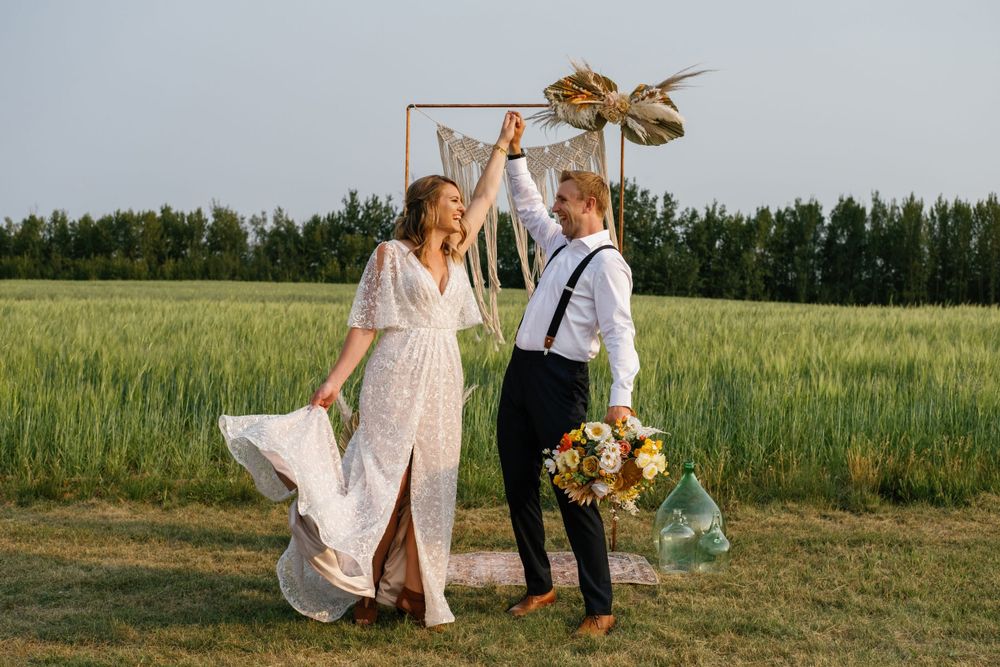 Bride and groom celebrating at Lakeview Events Barrhead Edmonton wedding venue wedding day photographer and videographer