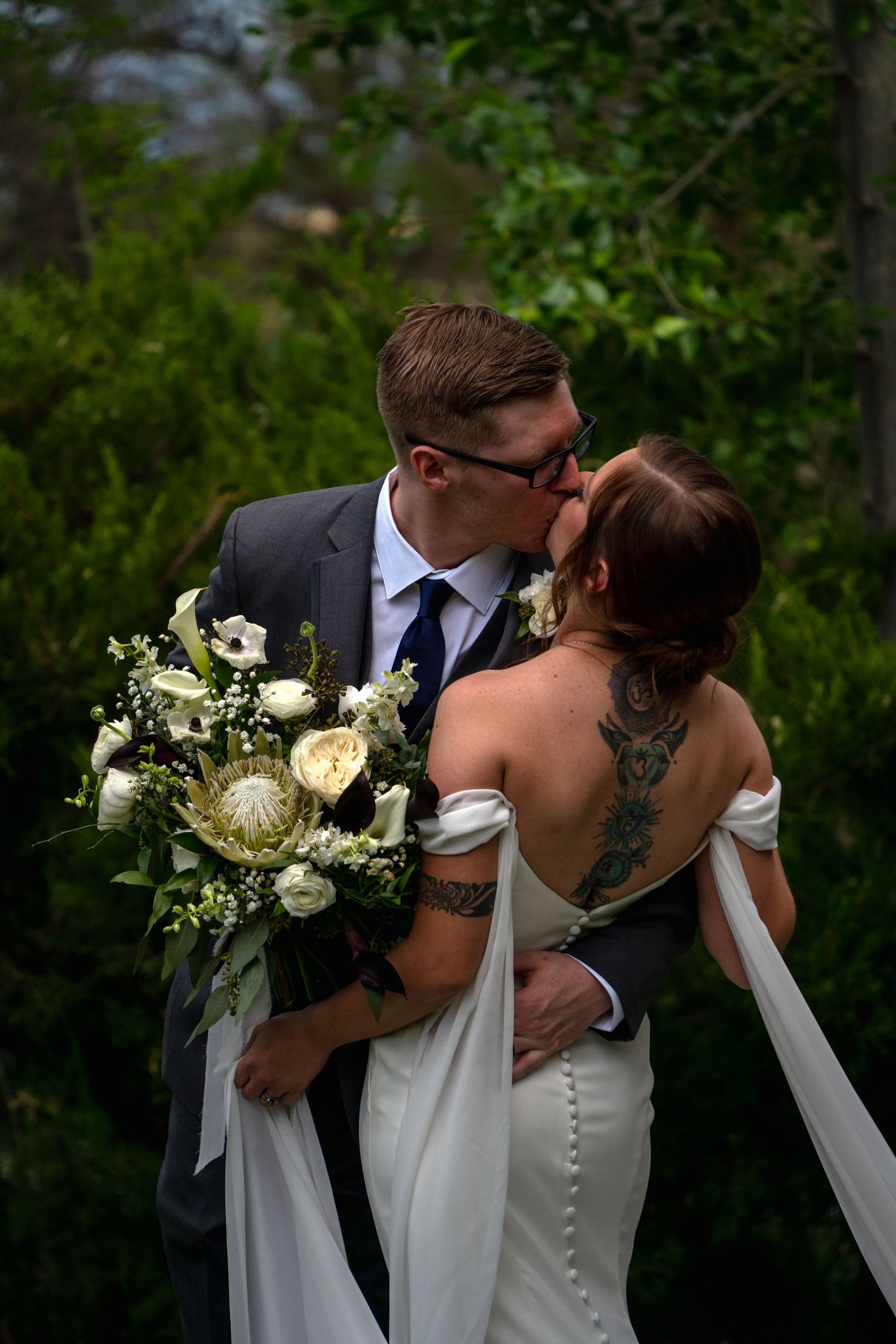 Romantic wedding moment with elegant white bouquet and flowing bridal gown details. Wedding Photography Sedona
