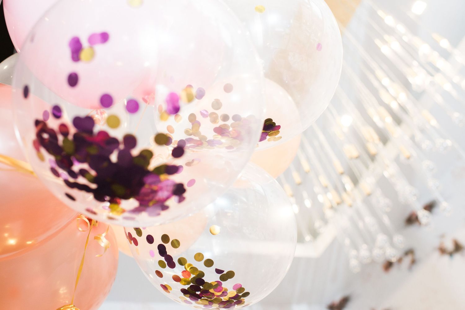 Decorative translucent balloons filled with colorful confetti creating a festive atmosphere.
