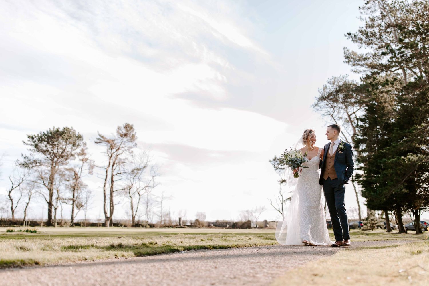 Newton Hall, Newton by the sea, wedding couple walking to stunning wedding venue