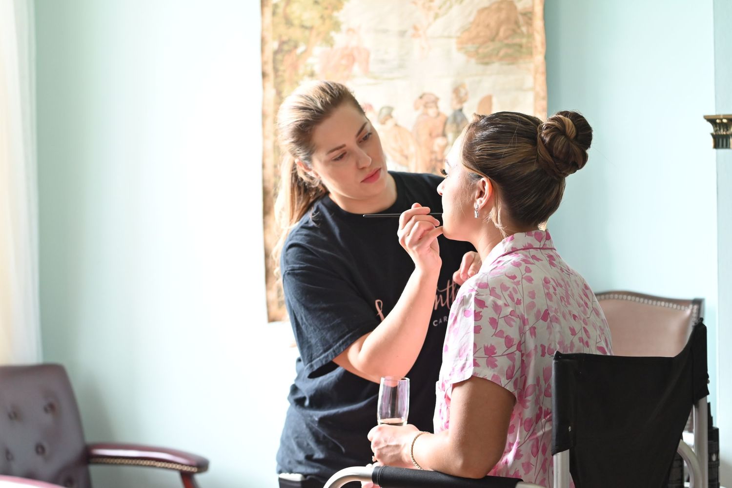 Bride applying makeup in preparation for her wedding.