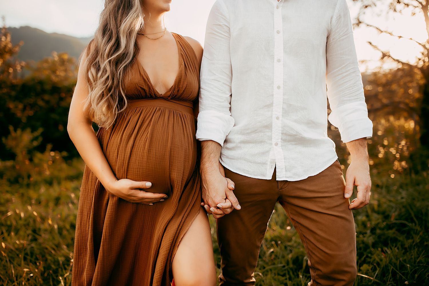 A couple hold hands during their maternity photoshoot in Shenandoah National Park.