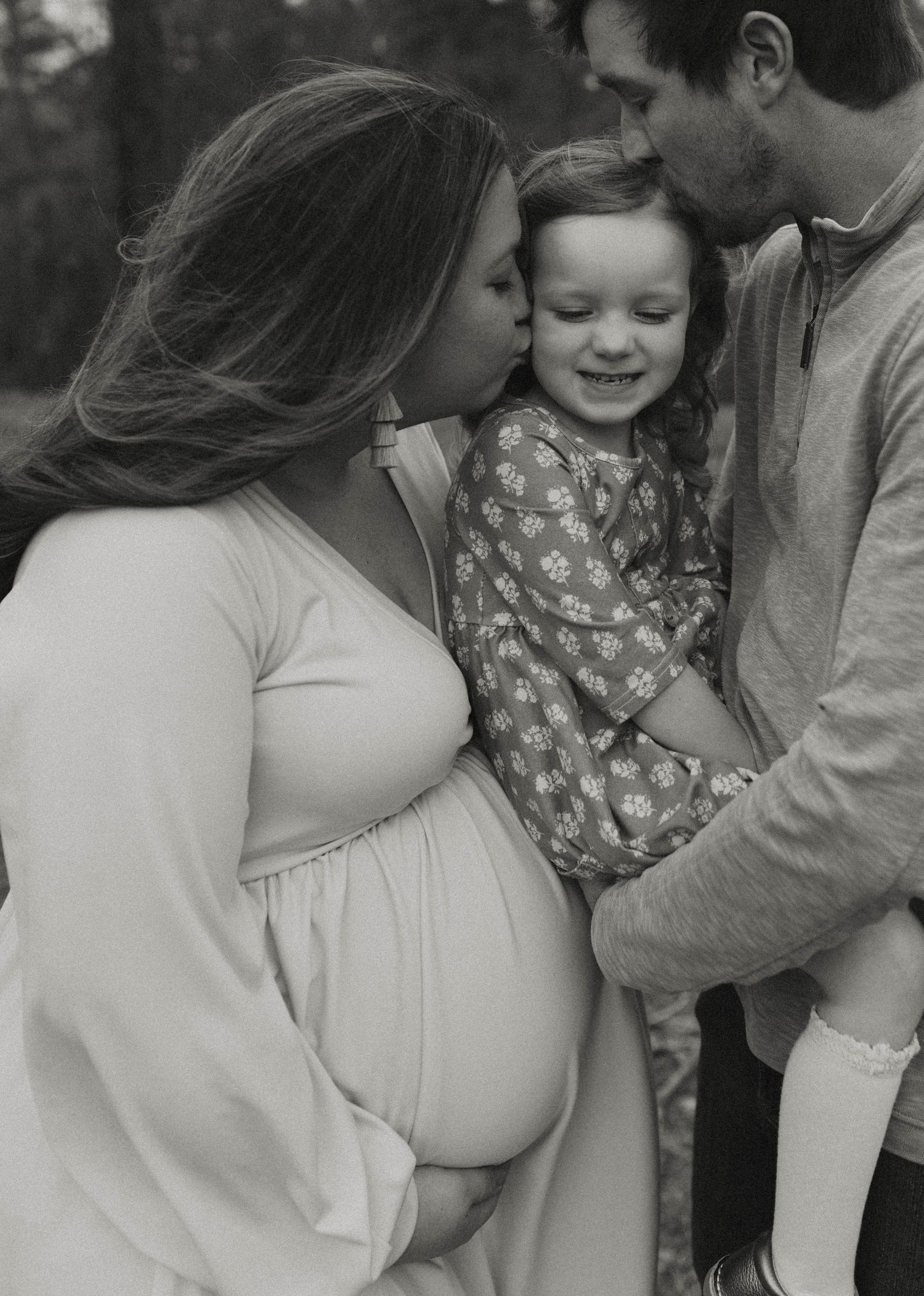 Black and white maternity portrait in casual setting.