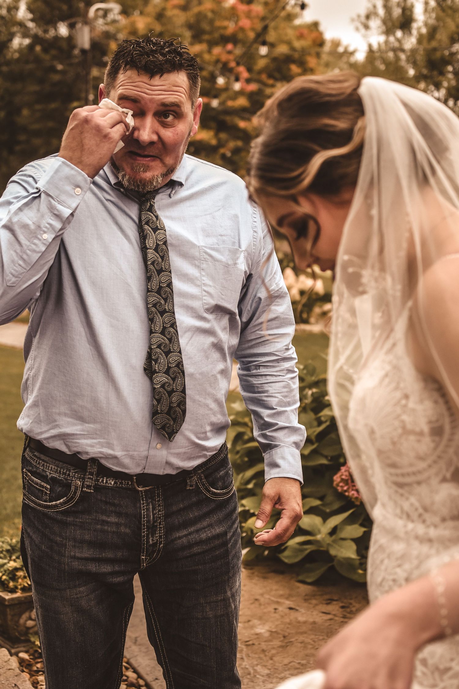 Emotional moment captured during outdoor wedding ceremony.