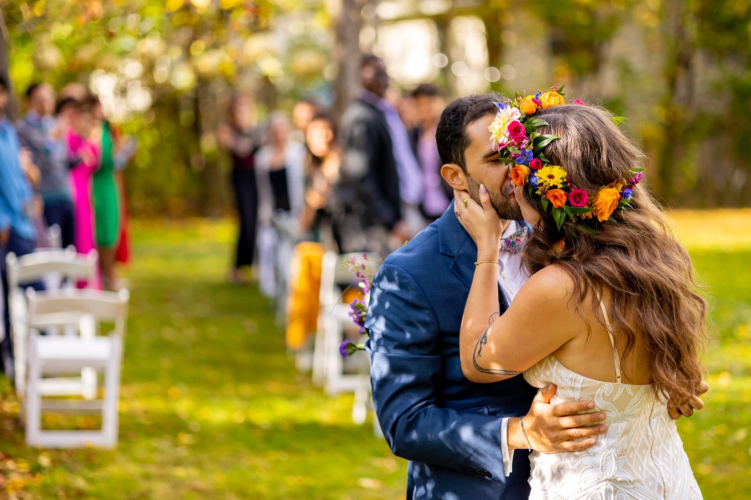 A joyful autumn wedding celebration with colorful fall foliage in the background.