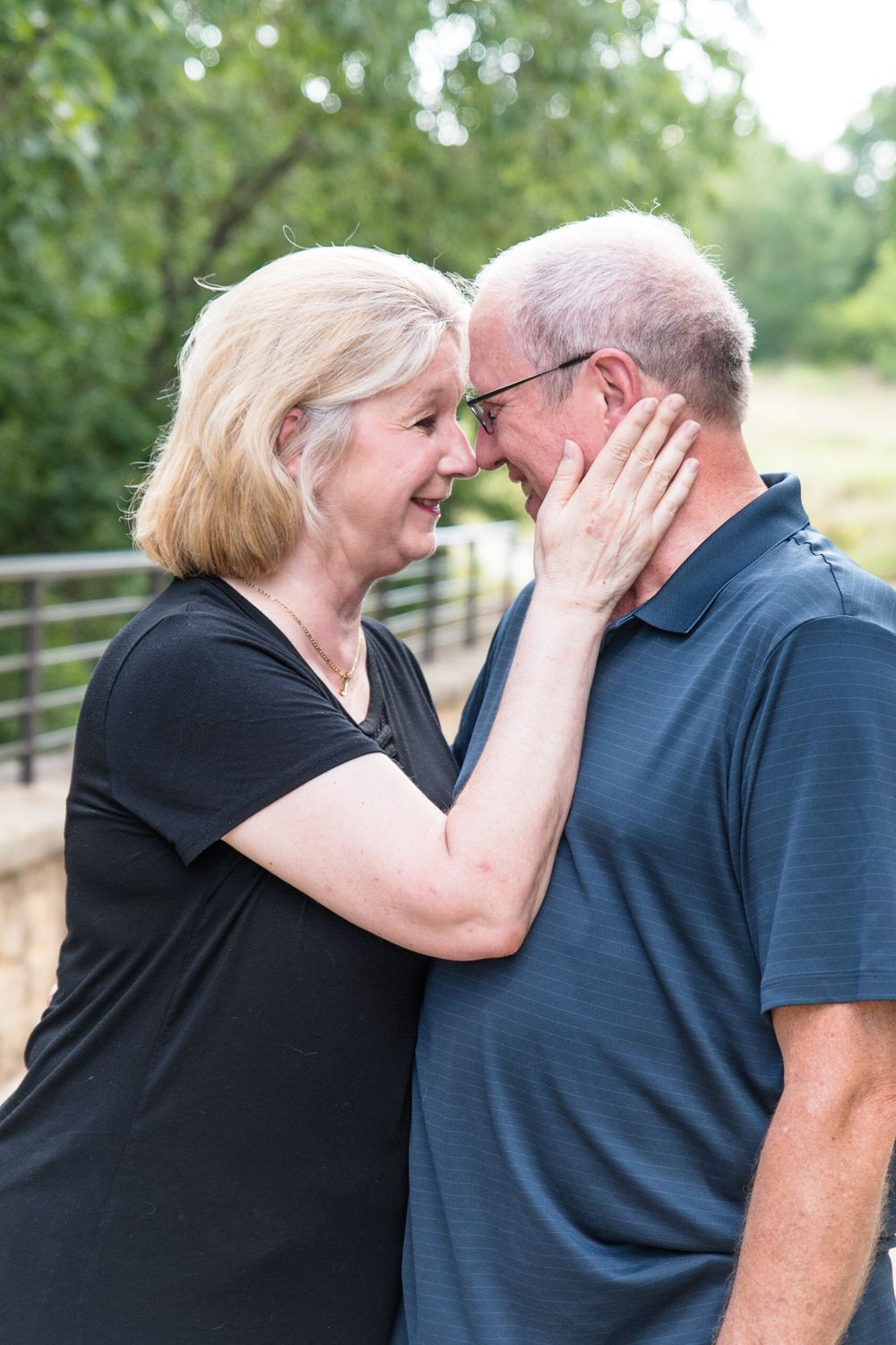Intimate moment between couple sharing tender embrace outdoors.