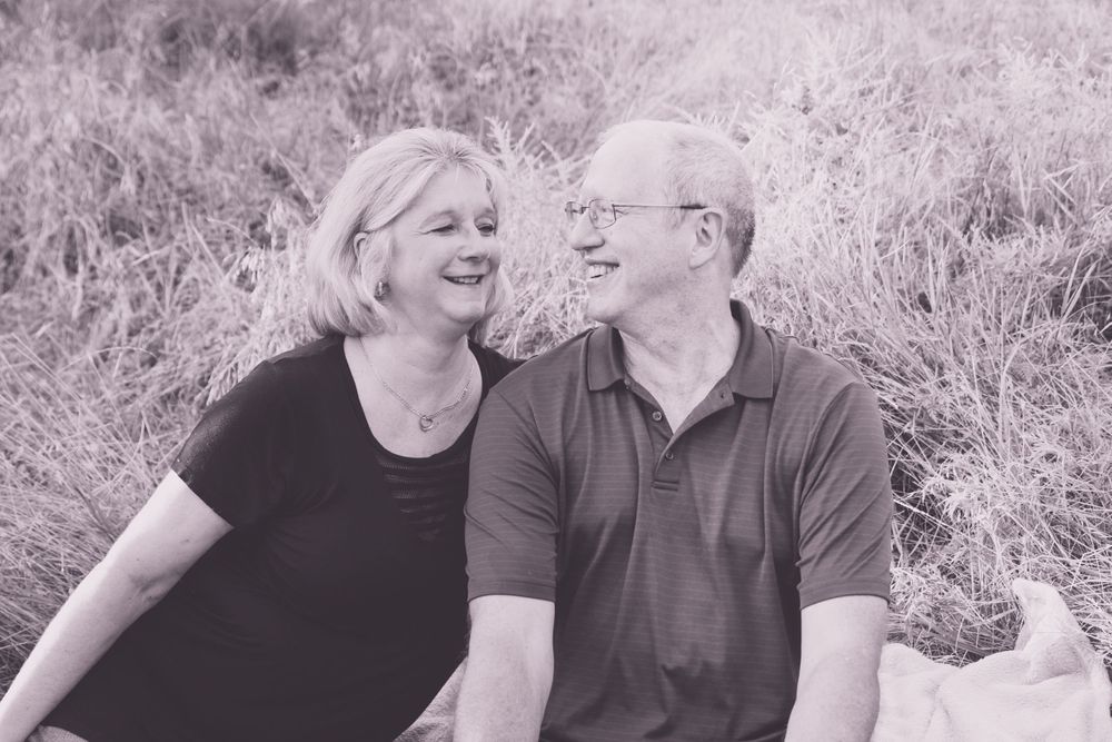 Black and white portrait of couple sharing joyful moment together outdoors.