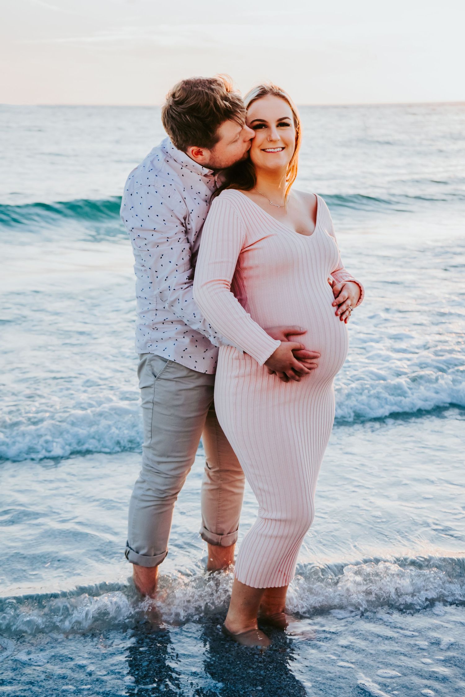 Outdoor Maternity Session Upham Beach, St. Pete, FL; Couple posing on beach at sunset