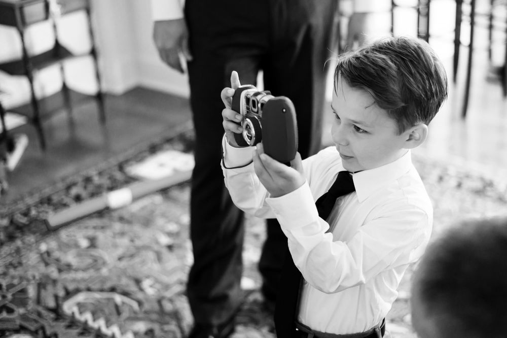 Young man taking pictures at wedding in Ohio.