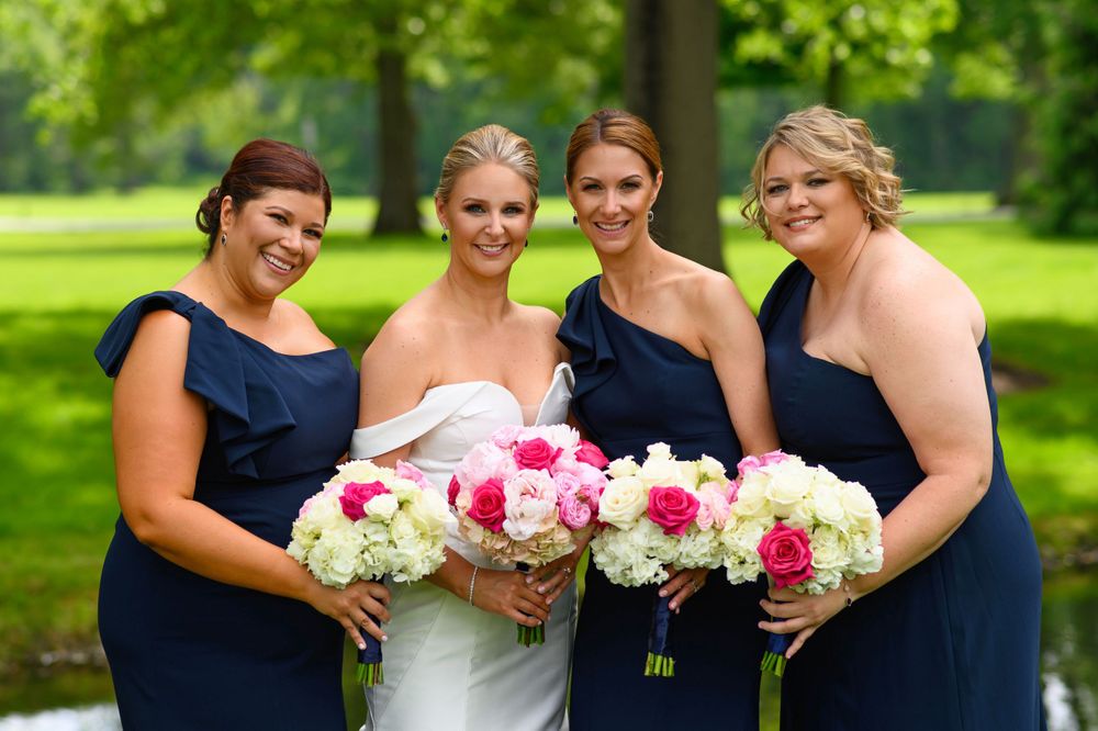 Bride and bridesmaids outdoors at Chagrin Valley Hunt Club.