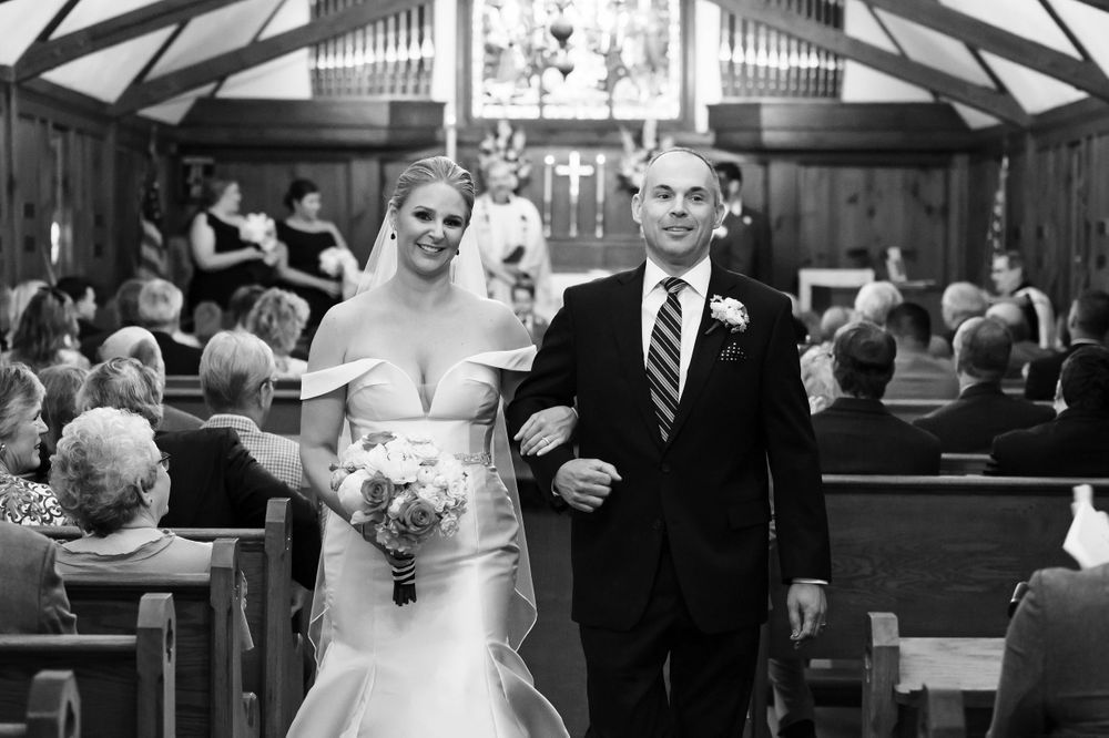 Bride and groom walking aisle after wedding ceremony at St. Huberts Episcopal Church in Kirtland Hills, Ohio.