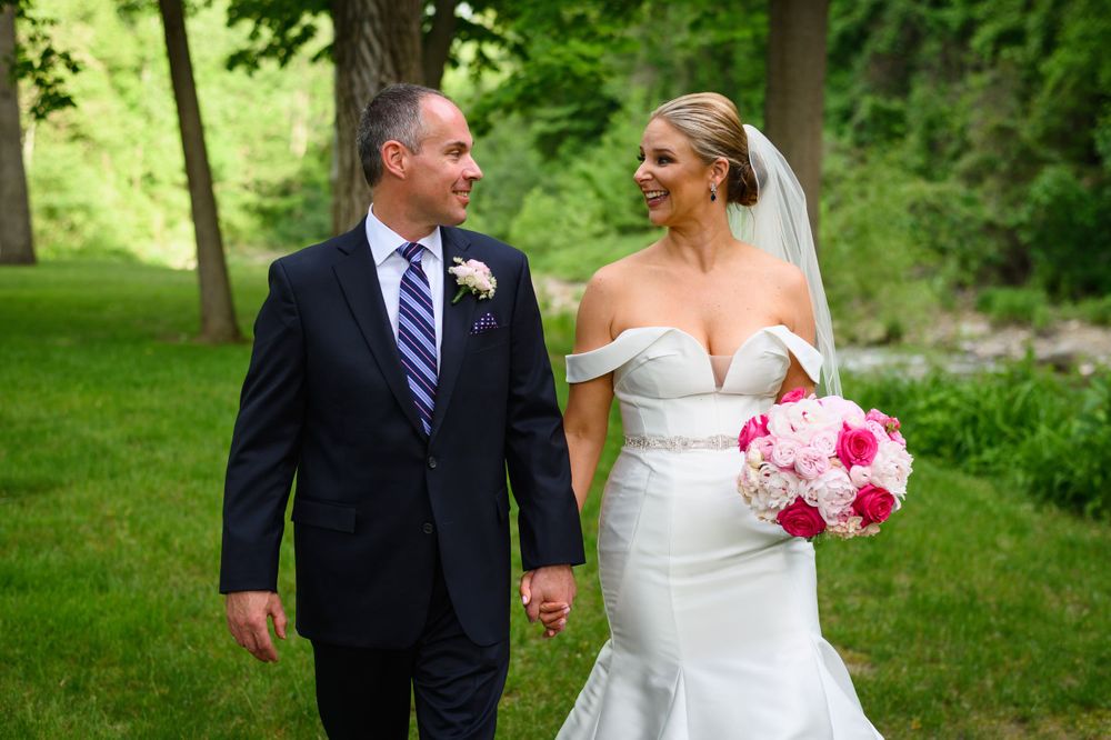 Bride and groom walking outdoors on wedding day in Kirtland, Ohio.