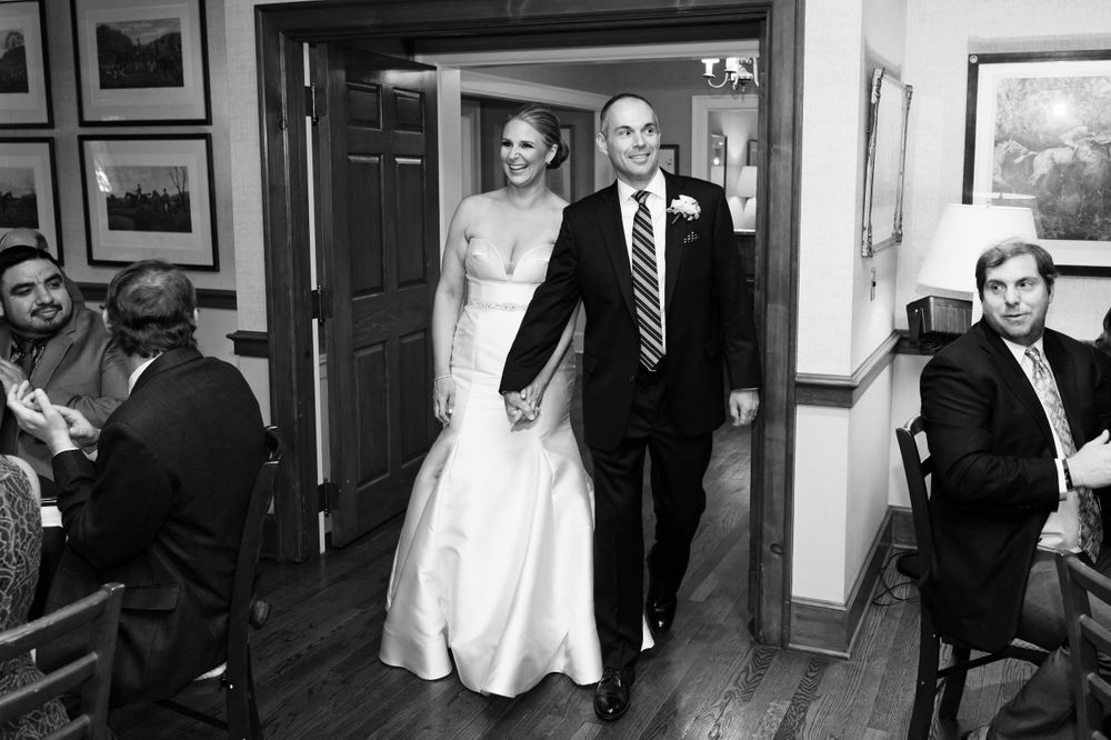 Bride and groom walking into reception at Chagrin Valley Hunt Club.
