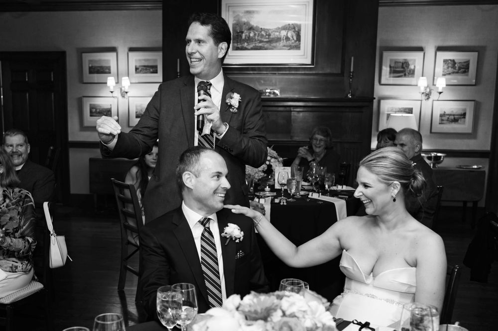 Groomsman toasts during wedding reception at Chagrin Valley Hunt Club.