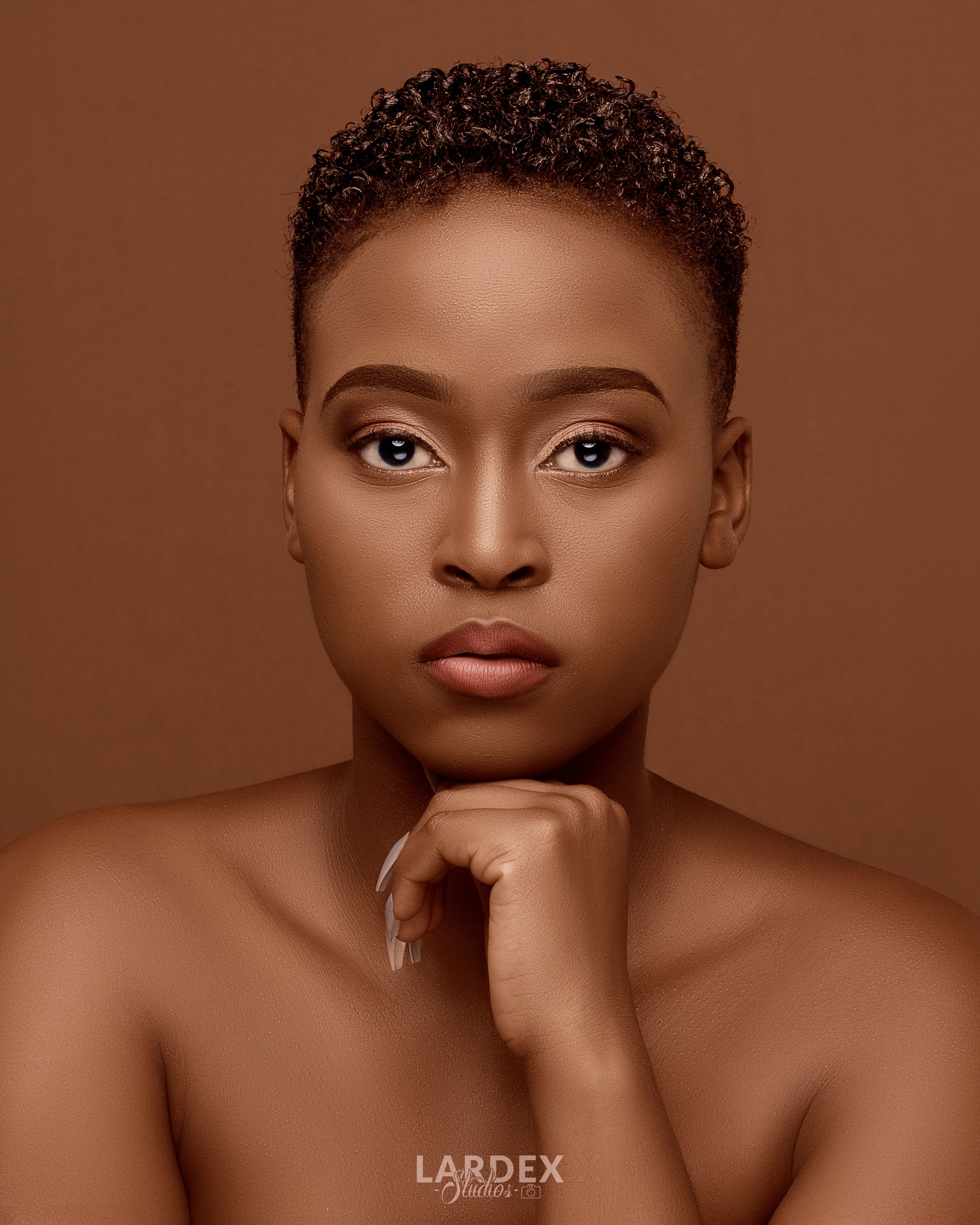 Classic beauty portrait with natural makeup and short cropped hair.
