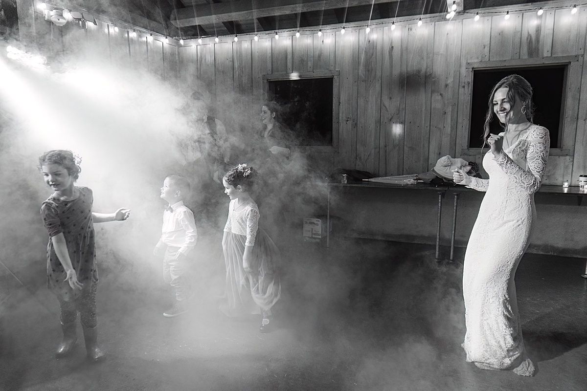 Photo of bride dancing with ring bearer and flower girls at wedding reception