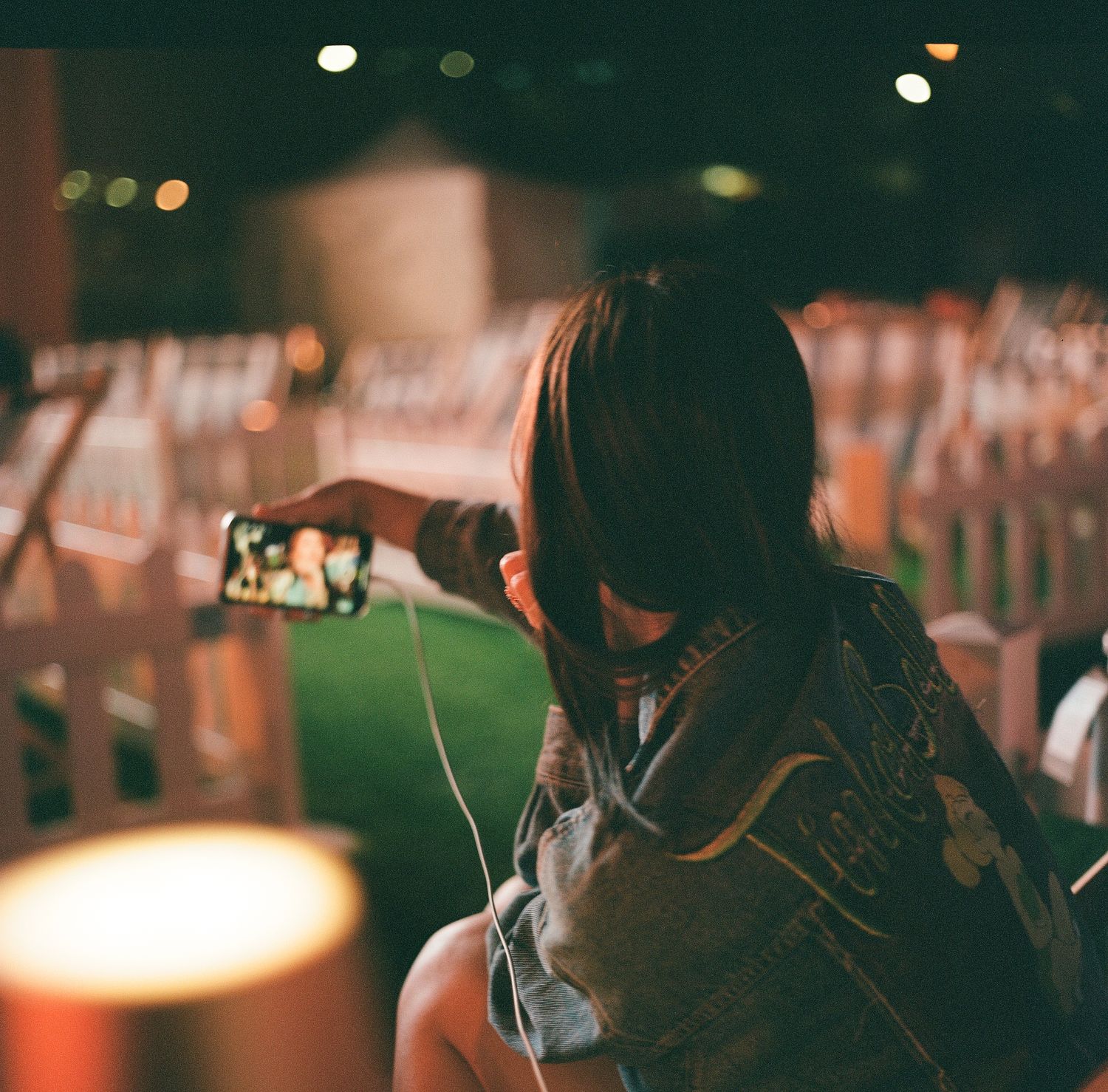 A image of a girl and her friend taking a selfie, photography.