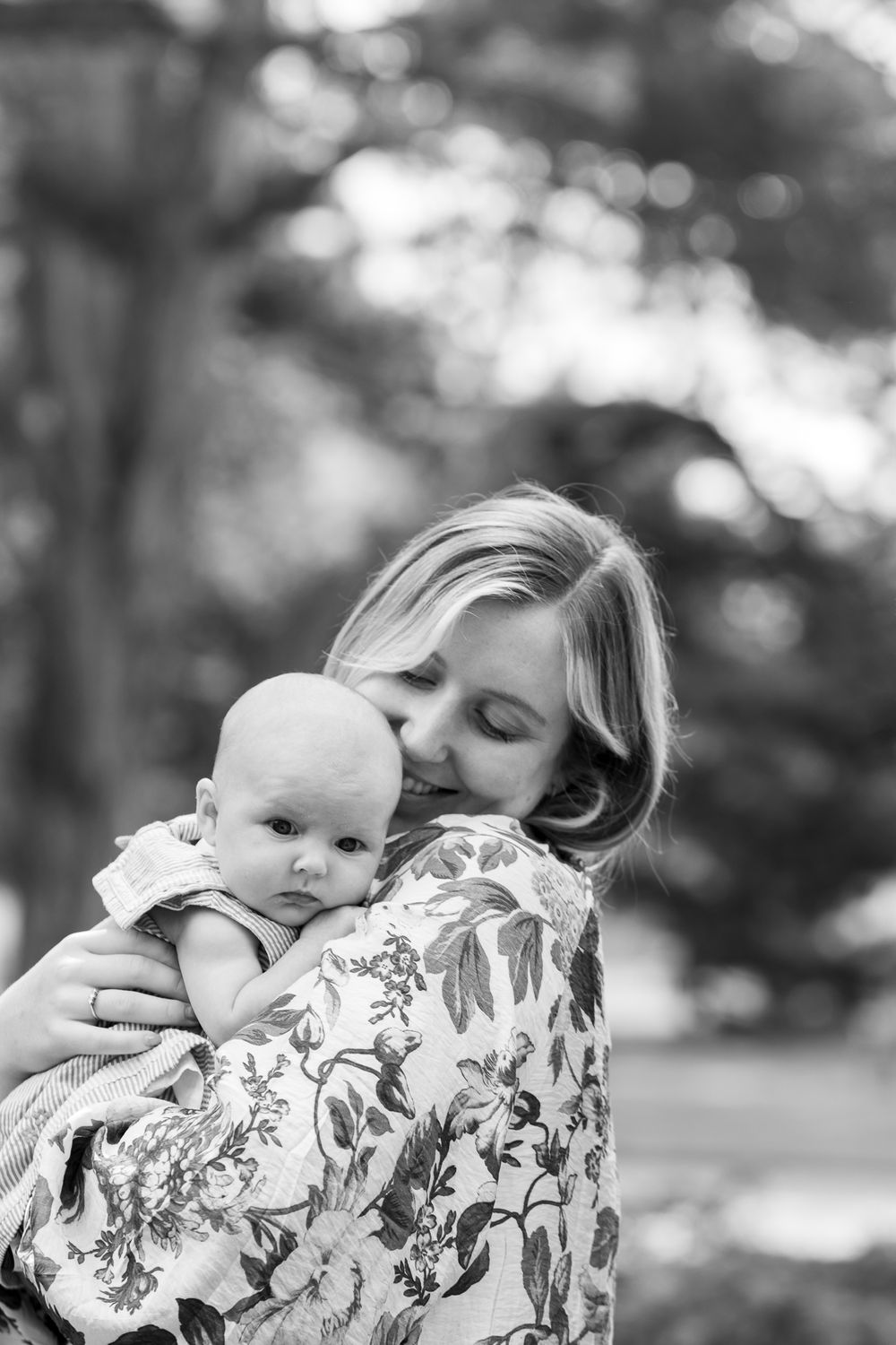 Mother hugs her baby in the botanical gardens in Cambridge, UK