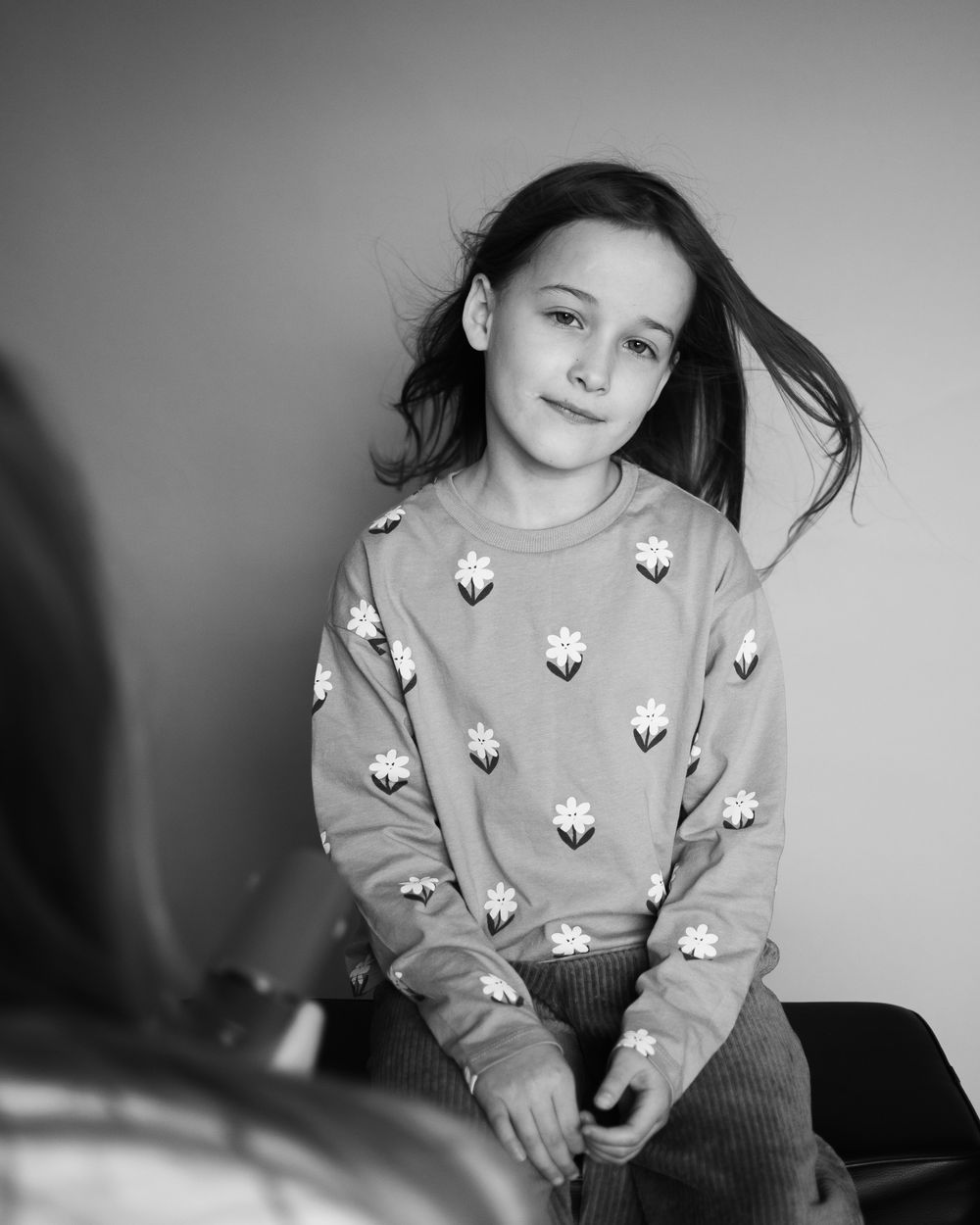 A girl sitting in a photo studio in Cambridge, UK