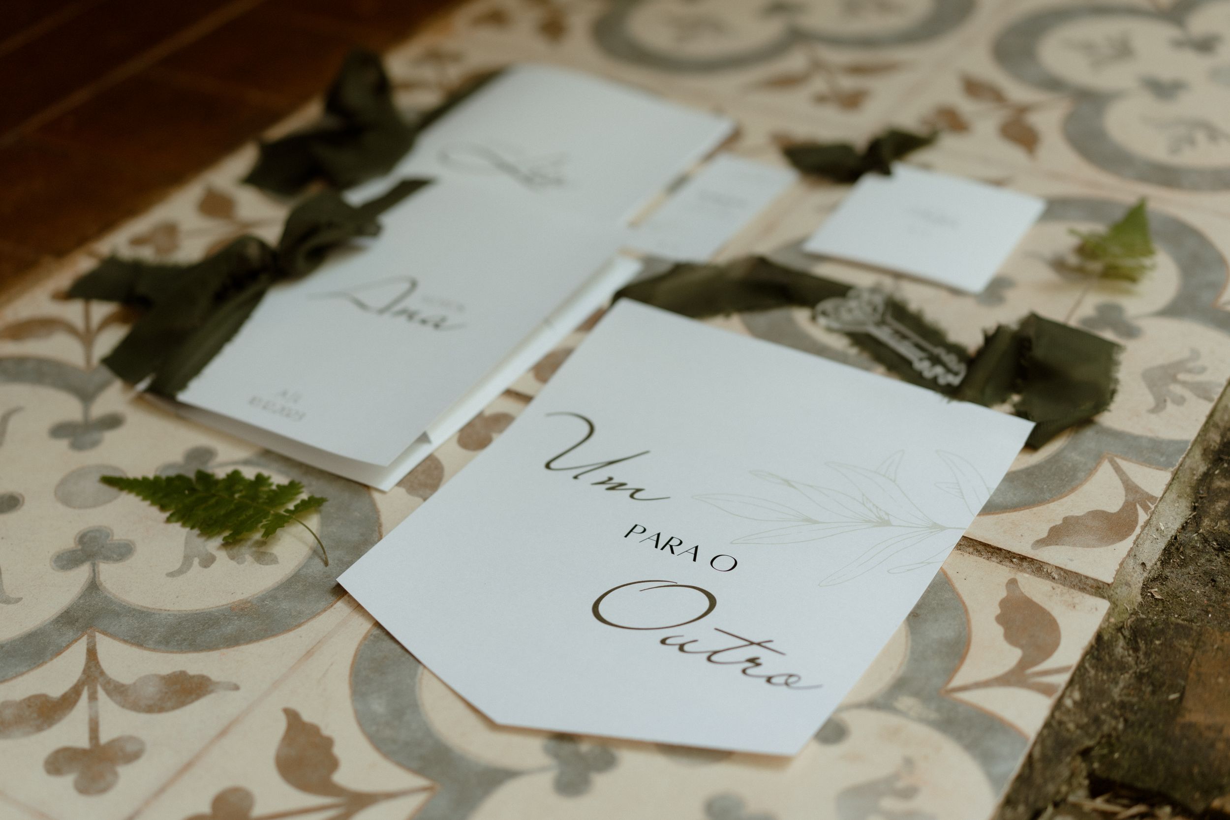 Wedding invitation cards arranged on a decorative patterned surface.