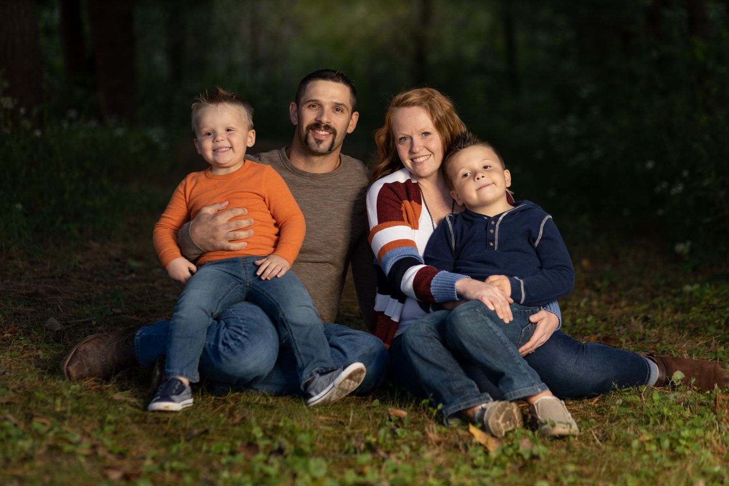 A family cuddled together just after sunset.
