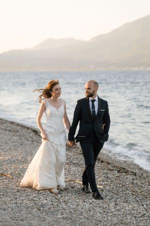 Romantic seaside wedding portrait with mountains and ocean in the background.