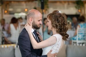 A tender moment between newlyweds sharing an intimate dance at their wedding reception.