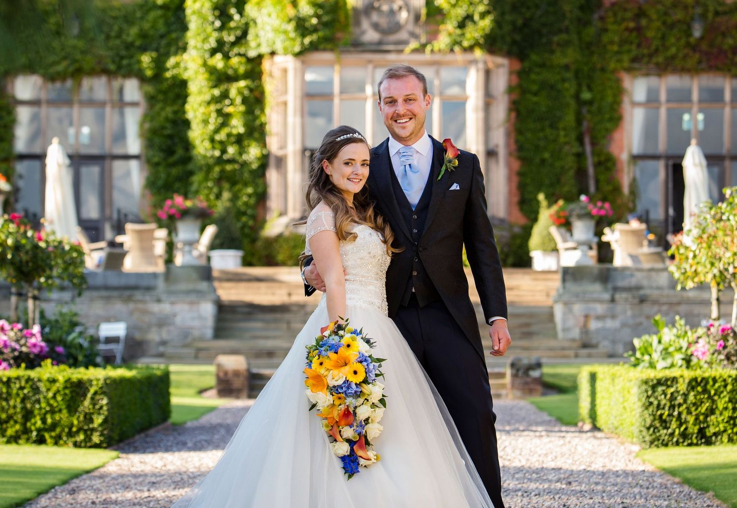 bride and groom couple wedding photography outside hoar cross hotel with colourful flowers