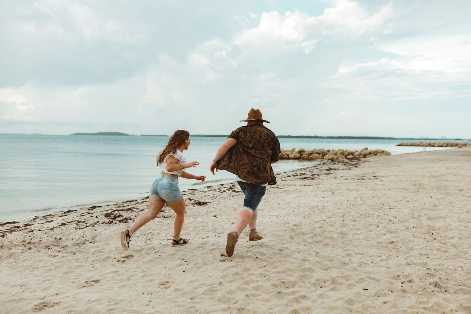 Couple running on the beach engagement photo Florida destination wedding
