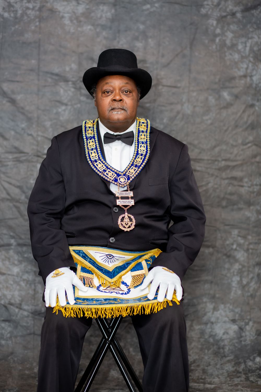 Formal portrait in Masonic regalia with decorative apron and ceremonial medallion.