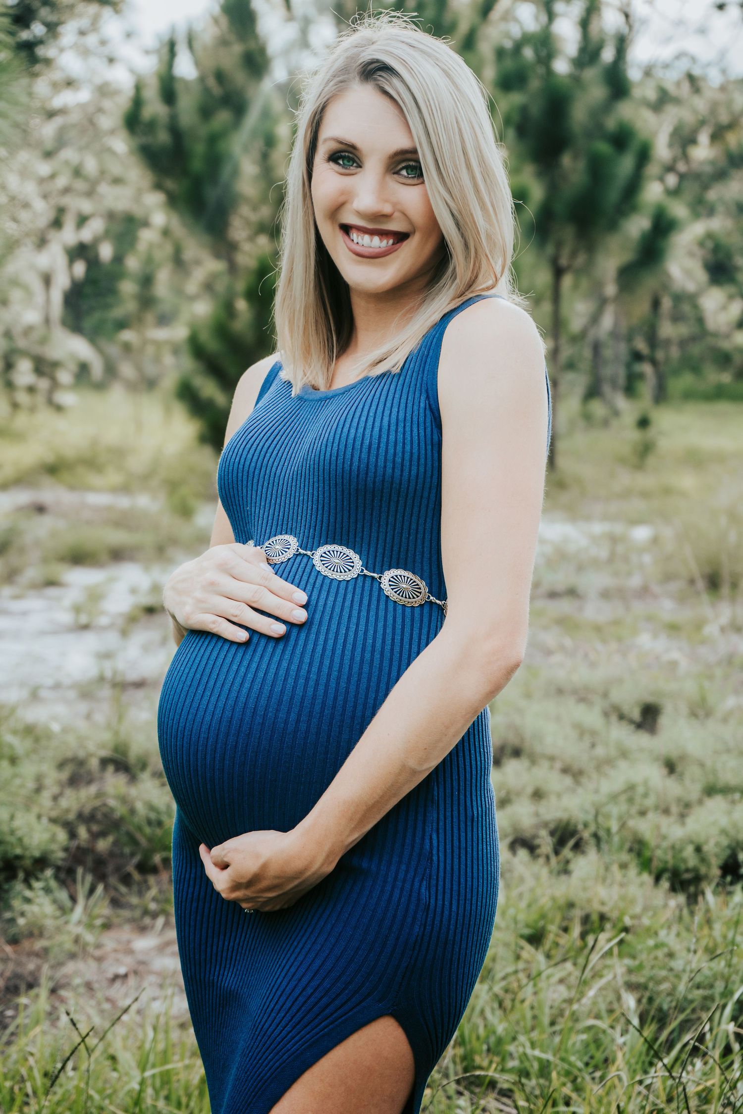 Outdoor Maternity Session at Thatcher Park, Lithia, FL; mother embracing pregnancy belly in the scrub brush