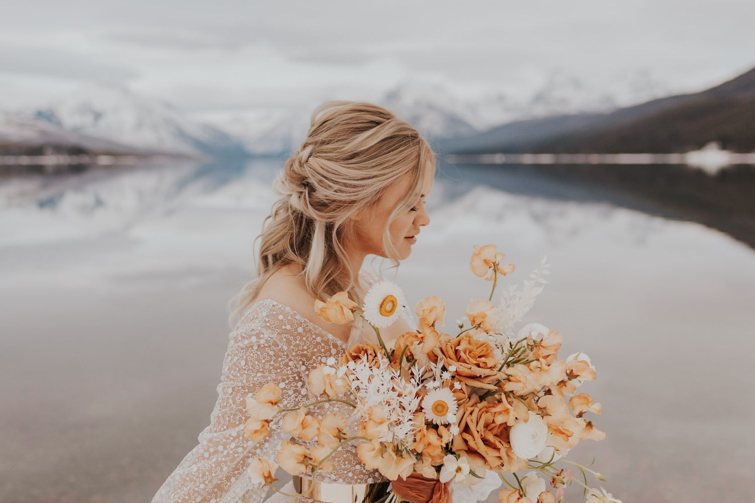 Bride holding bouquet of flowers in sparkly tulle wedding dress in Glacier National Park