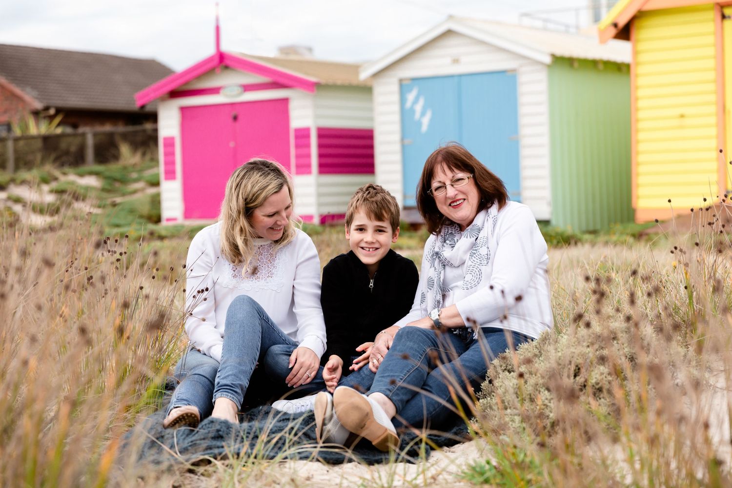 Generations, a young boy at the beach with his mother and his grandmother.