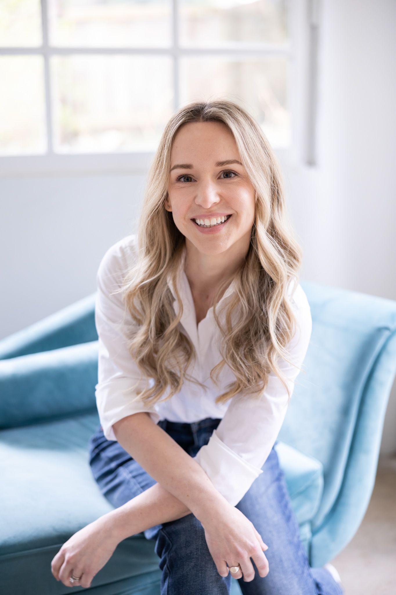 woman headshot in spaceflight Woodinville, WA sitting on blue couch