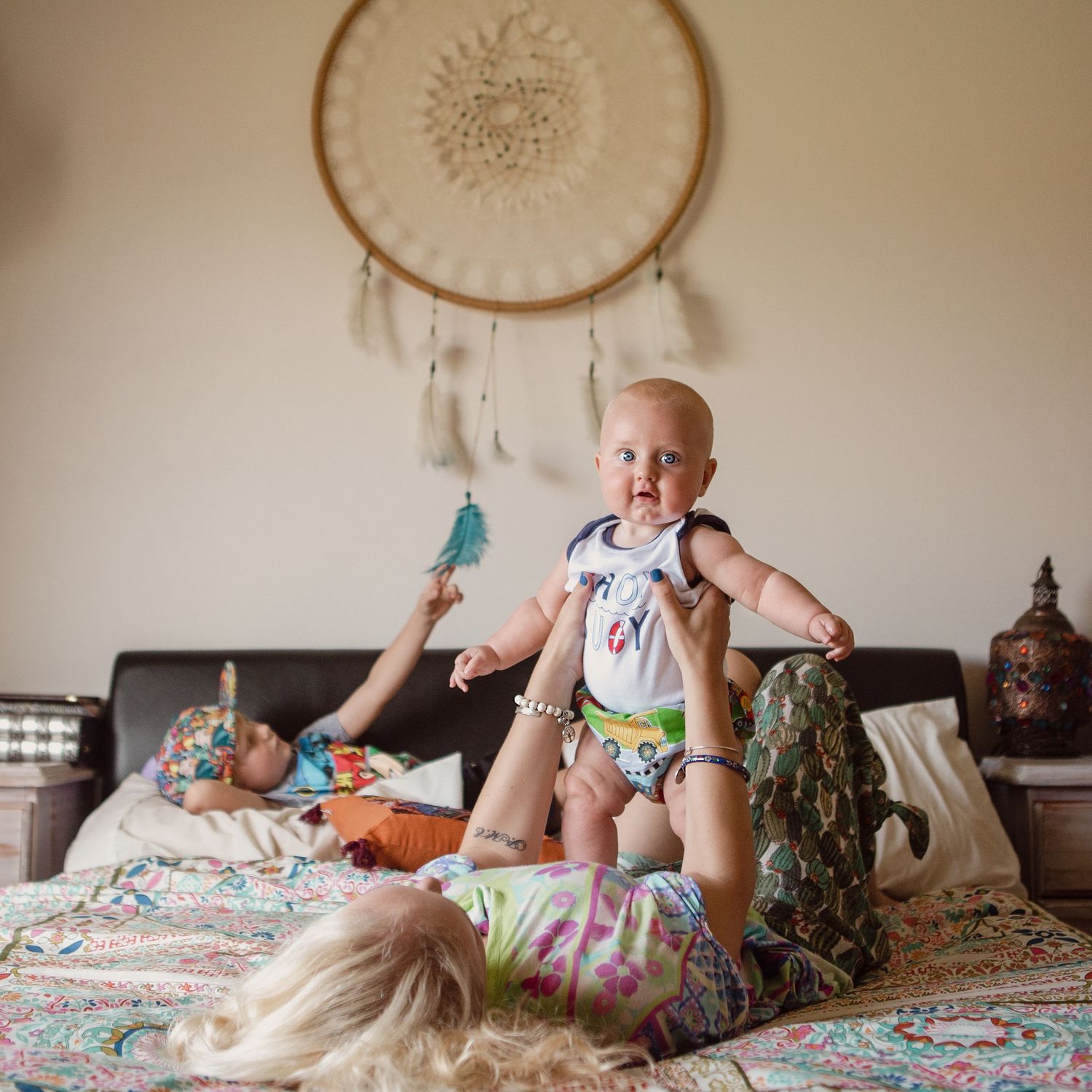 Lifestyle photography, Boy playing with dream catcher, mother and laying with her baby.