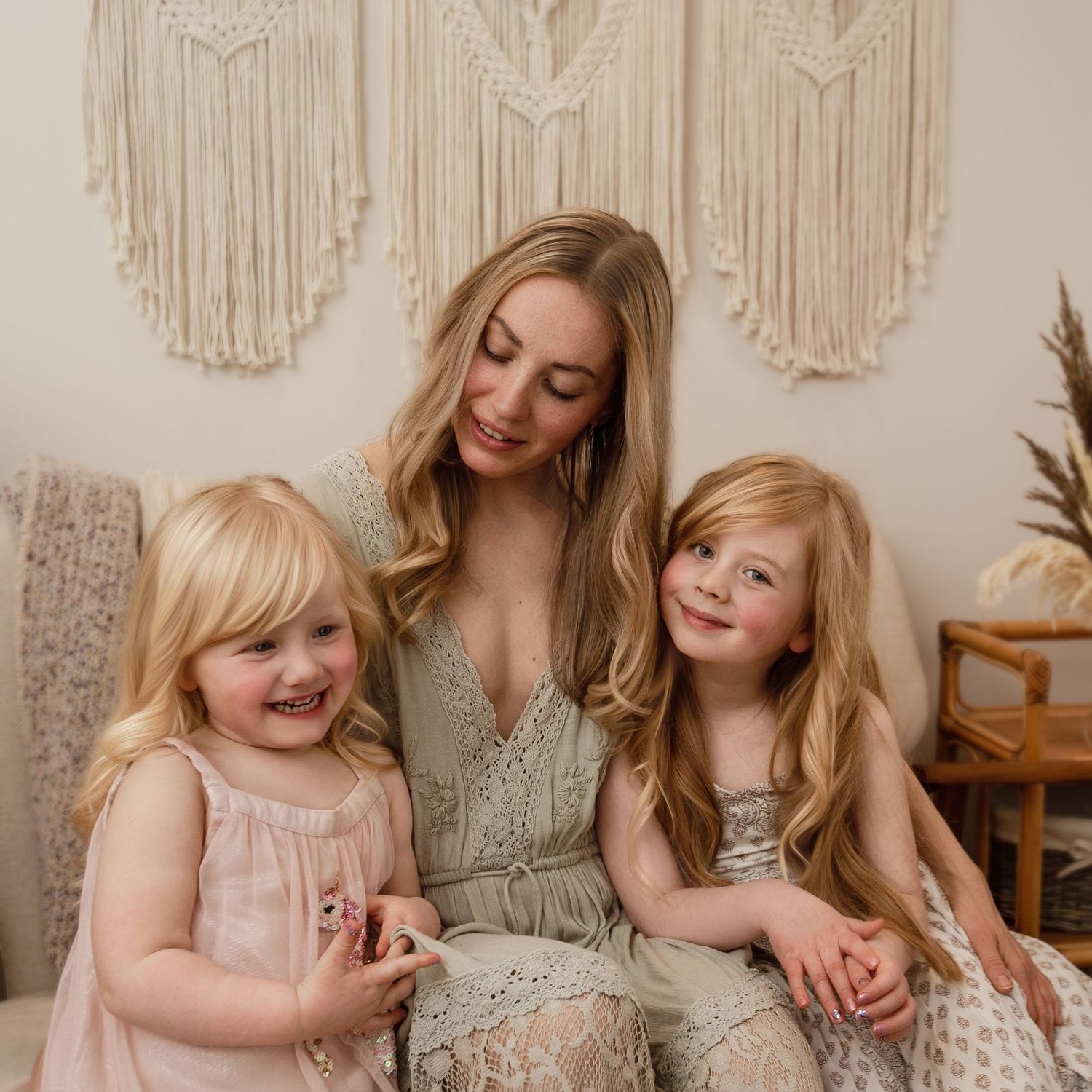 Motherhood photography. Mothers day photoshoot. mum sitting with her daughters.