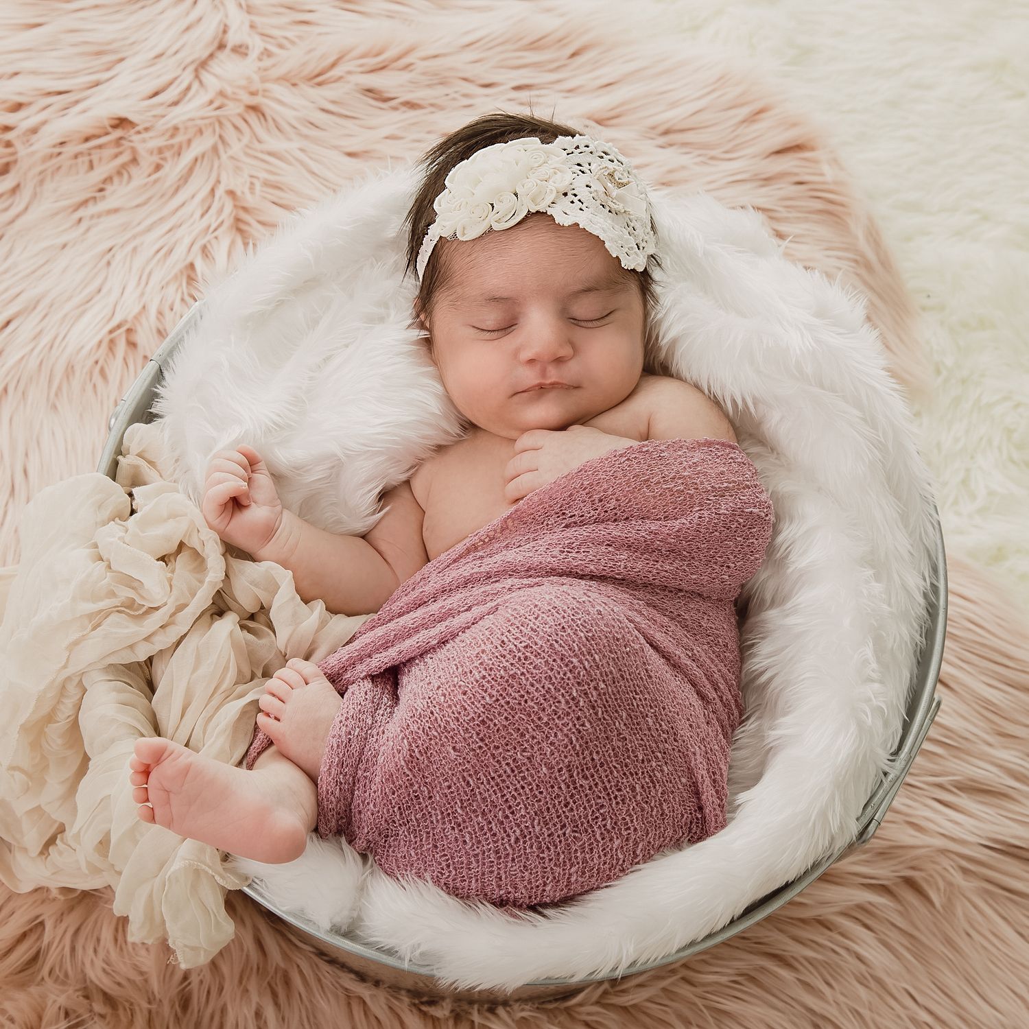 Newborn sleeping in her newborn photoshoot.